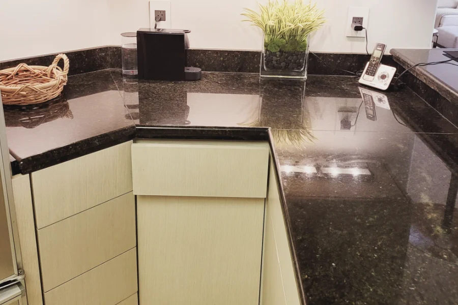 A modern kitchen featuring white oak cabinets, a sleek counter, and a stainless steel sink, showcasing a clean design.