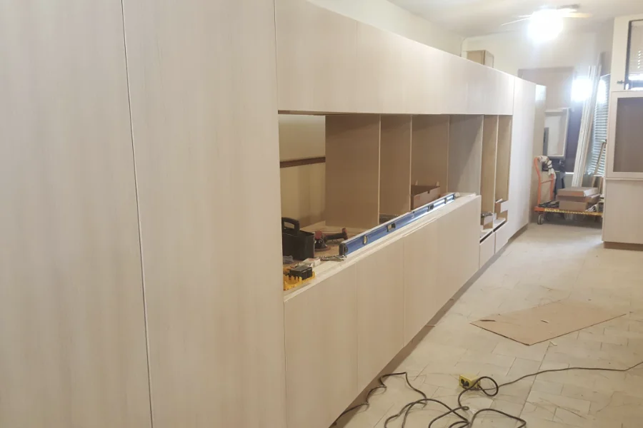 An image of white oak kitchen cabinets being constructed, situated in the middle of the room.